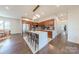 Open kitchen with a large island with chairs, stainless steel appliances and view to the dining area at 6017 Rose Valley Dr, Charlotte, NC 28210