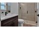 Modern bathroom featuring tile shower with glass door, dark cabinets and a white countertop sink at 6055 Brush Crk, Monroe, NC 28110