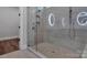 Bathroom with glass enclosed shower, grey tile, and illuminated mirrors at 6055 Brush Crk, Monroe, NC 28110