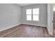 Bright bedroom featuring hardwood floors, a large window, and neutral paint color at 6055 Brush Crk, Monroe, NC 28110