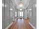 Grand hallway featuring elegant light fixtures, wood floors, and wainscoting at 6055 Brush Crk, Monroe, NC 28110