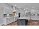 A great view of kitchen featuring hardwood floors, stone counters, stainless appliances and pendant lights at 6055 Brush Crk, Monroe, NC 28110