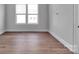 Bright room featuring wood flooring, a large double window with blinds, plus neutral paint at 6055 Brush Crk, Monroe, NC 28110