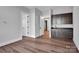 Spacious room with stylish wood flooring, a wet bar with dark cabinets and trim, plus neutral walls at 6055 Brush Crk, Monroe, NC 28110