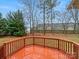 Wood deck in backyard surrounded by mature trees and a wooden fence at 609 Sunset Point Dr, Rock Hill, SC 29732