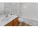 Bathroom featuring a vanity with storage, a toilet, a mirror and a shower-tub combo at 609 Sunset Point Dr, Rock Hill, SC 29732