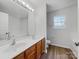 Bathroom featuring double sinks, a bathtub, a toilet and wood cabinets at 609 Sunset Point Dr, Rock Hill, SC 29732
