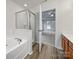 Bright bathroom with a soaking tub, a glass-enclosed shower, and a neutral color palette at 609 Sunset Point Dr, Rock Hill, SC 29732