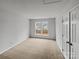 Neutral carpeted bedroom featuring fresh white paint and a large window providing natural light at 609 Sunset Point Dr, Rock Hill, SC 29732