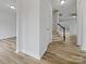Bright hallway featuring hardwood floors, white walls, and natural light at 609 Sunset Point Dr, Rock Hill, SC 29732