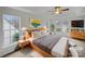 Sunlit main bedroom featuring tray ceiling, a ceiling fan, and large windows for plenty of natural light at 609 Sunset Point Dr, Rock Hill, SC 29732