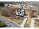 Aerial view of a well-maintained home with a long driveway and mature trees in a neighborhood at 662 Georgie St, Troutman, NC 28166