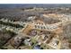 An aerial shot highlights neighborhood development near wooded areas, displaying a mix of established and new homes at 662 Georgie St, Troutman, NC 28166