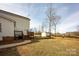 Side view of the house featuring a wooden deck, shed, and green lawn at 662 Georgie St, Troutman, NC 28166