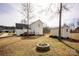 Spacious backyard featuring a wooden deck, fire pit, and storage shed at 662 Georgie St, Troutman, NC 28166