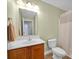 Bathroom with a wooden vanity, mirror and shower with curtain at 662 Georgie St, Troutman, NC 28166