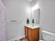 A full bathroom with a wooden vanity, mirror and walk-in shower at 662 Georgie St, Troutman, NC 28166
