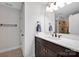 Bathroom boasts marble counters, dark wood vanity, modern fixtures, and separate room for toilet at 662 Georgie St, Troutman, NC 28166