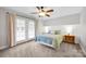 Bright primary bedroom with large windows, carpet floor and ceiling fan at 662 Georgie St, Troutman, NC 28166