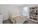 Bedroom featuring a large bed with a colorful blanket, and a bookshelf at 662 Georgie St, Troutman, NC 28166
