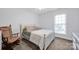 Comfortable bedroom with a rocking chair, and a large bed and window at 662 Georgie St, Troutman, NC 28166