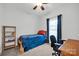 Bedroom featuring a twin bed, window with dark curtains, desk and bookshelf at 662 Georgie St, Troutman, NC 28166