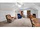 Bright and airy bonus room with soft carpet, comfortable seating, and built-in bookshelves at 662 Georgie St, Troutman, NC 28166