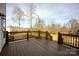 Spacious outdoor wooden deck area with railings and tree views at 662 Georgie St, Troutman, NC 28166