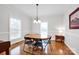 Bright dining room with hardwood floors, chandelier, and large windows at 662 Georgie St, Troutman, NC 28166