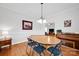 Dining room with hardwood floors, a chandelier, and a piano for entertaining at 662 Georgie St, Troutman, NC 28166