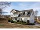 Charming two-story home with a double front porch and landscaped yard at 662 Georgie St, Troutman, NC 28166