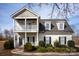 Charming two-story home with a covered porch, balcony, and well-manicured landscaping at 662 Georgie St, Troutman, NC 28166