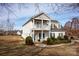 Charming two-story home with a covered porch, balcony, and manicured landscaping at 662 Georgie St, Troutman, NC 28166