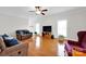 Open living room featuring wood floors, a ceiling fan, and ample natural light from multiple windows at 662 Georgie St, Troutman, NC 28166