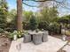 Charming backyard patio with flagstone paving, tasteful outdoor seating, and elegant landscaping at 6711 Conservatory Ln, Charlotte, NC 28210