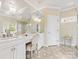 Spacious bathroom featuring double vanities, a makeup vanity, a large mirror, and a glass shower at 6711 Conservatory Ln, Charlotte, NC 28210