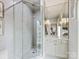 Modern bathroom showcasing a glass shower, mirrored walls, and a vanity with white cabinets at 6711 Conservatory Ln, Charlotte, NC 28210