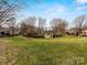 Well-manicured community green space with gazebo, mature trees, and manicured lawn at 6711 Conservatory Ln, Charlotte, NC 28210