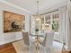 Bright dining room with glass table, modern chandelier, and artistic wall décor at 6711 Conservatory Ln, Charlotte, NC 28210