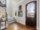 Elegant entryway featuring hardwood floors, a staircase, and a stylish front door at 6711 Conservatory Ln, Charlotte, NC 28210