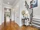 Bright entryway with hardwood floors, staircase with iron railings, and elegant chandelier at 6711 Conservatory Ln, Charlotte, NC 28210