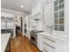 Gourmet kitchen featuring white cabinets, stainless steel appliances, and hardwood flooring at 6711 Conservatory Ln, Charlotte, NC 28210