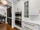 Close-up of the gourmet kitchen with built-in stainless ovens and designer backsplash at 6711 Conservatory Ln, Charlotte, NC 28210
