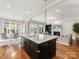 Open concept kitchen with large island, pendant lighting, and hardwood floors at 6711 Conservatory Ln, Charlotte, NC 28210