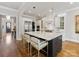 Modern kitchen with island seating, pendant lighting, and stainless steel appliances at 6711 Conservatory Ln, Charlotte, NC 28210