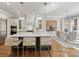 Bright, modern kitchen with a large island, pendant lights, and stainless steel appliances at 6711 Conservatory Ln, Charlotte, NC 28210