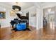 Elegant living room with hardwood floors, grand piano, and stylish lighting fixtures at 6711 Conservatory Ln, Charlotte, NC 28210