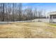 Large backyard with a swing set and a basketball hoop, enclosed by a white picket fence at 7535 Meridale Forest Dr # 107, Charlotte, NC 28269