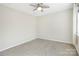 Bedroom has neutral walls and carpet, a modern ceiling fan, and a sunlit window at 7535 Meridale Forest Dr # 107, Charlotte, NC 28269