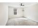 Bright bedroom with neutral carpet, a ceiling fan, and a window offering natural light at 7535 Meridale Forest Dr # 107, Charlotte, NC 28269